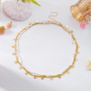 Detail of layered bohemian seashell choker necklace with starfish and pearl pendants