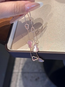 Macro detail of rose gold wulu pendant featuring pink shell inlay and pavé zircon stones