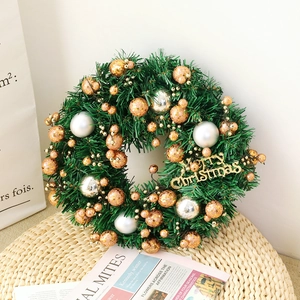 Artificial Christmas wreath with pine needles, silver baubles, and Merry Christmas sign