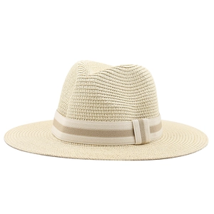 Detailed view of beige straw hat featuring striped ribbon band and tight woven texture