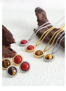 Detailed view of snake bone chain necklace and tiger eye stone pendant jewelry set