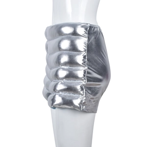 Side view of metallic silver quilted shorts showing thick padding and high-shine fabric