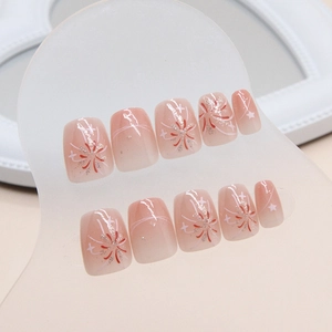 Short ballet press-on nails with nude pink blush gradient and silver firework patterns