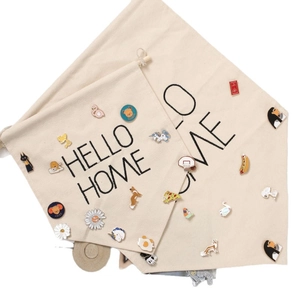 Beige canvas banner with Hello Home print and colorful enamel pin collection display