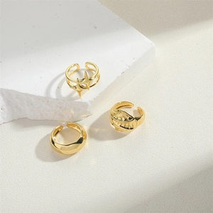 Three-piece set of adjustable 14K gold plated rings featuring star and embossed patterns