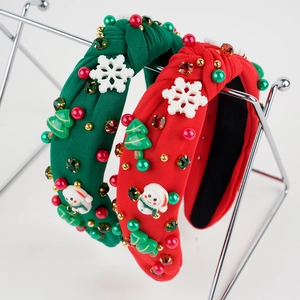Detail of Christmas headband showing velvet knot with sparkling rhinestones and snowmen