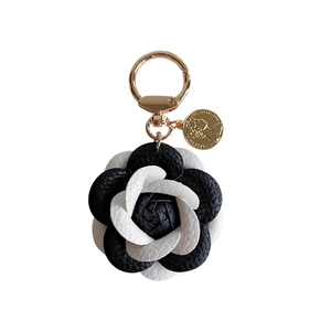 Classic black and white leather camellia keychain with gold coin and lobster clasp