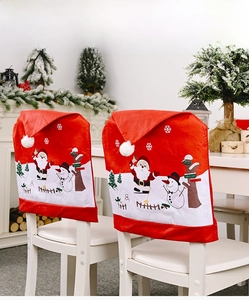 Close-up of Christmas chair covers with Santa Claus and Snowman prints on a dining chair