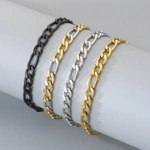 Minimalist Figaro chain bracelets in black, gold, and silver finishes on a display