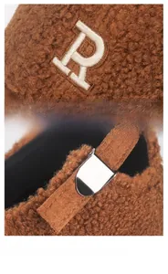 Detail of Teddy fleece baseball cap featuring R embroidery and adjustable metal buckle