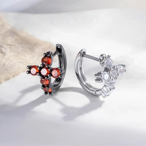 Cross hoop earrings with red zircon in black metal and clear stone in silver finish