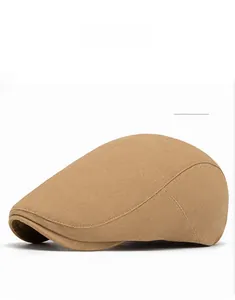 Detail view of khaki cotton newsboy cap featuring curved seams and premium twill texture