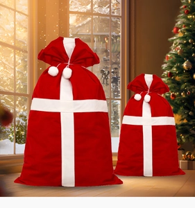 Detail of red and white flocked Christmas gift bags with drawstrings in two sizes