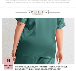 Detail of dark green silk satin pajamas set with elegant white piped cuffs and smooth texture