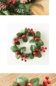 Detailed view of Christmas wreath with red berries, pine cones, and green needles