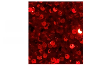 Detail of red Christmas stocking featuring shiny sequin fabric and festive texture
