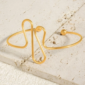Minimalist 18k gold plated stainless steel open bangle with abstract wavy lines on stone