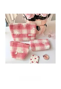 Three-piece set of pink checkered plush makeup bags with delicate bow embroidery detail
