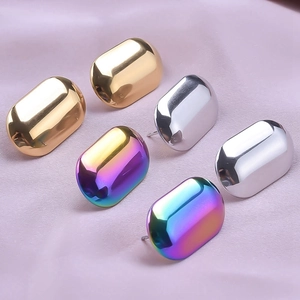 Polished stainless steel oval stud earrings in gold, silver and rainbow on purple satin