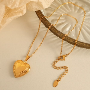 Elegant gold vintage heart locket necklace with floral engraving on an O-chain link