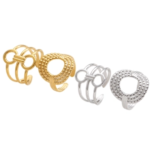 Macro detail of geometric open rings in gold and silver finish with textured multi-layer band