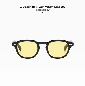Detail of vintage round eyeglasses with glossy black frames and vibrant yellow lenses