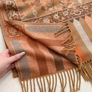 Detail shot of ethnic floral scarf fringe and thick core-spun yarn jacquard fabric texture