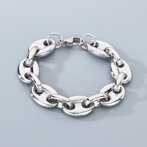 Close-up of silver pig nose chain bracelet with metal lobster clasp on grey background