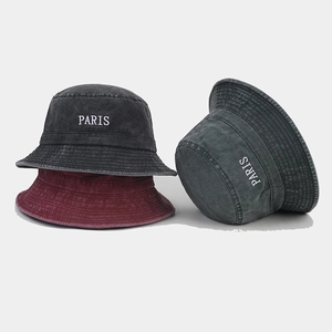 Detailed embroidery of PARIS on washed cotton bucket hats in dark grey and burgundy