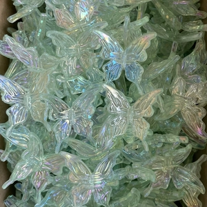 Macro shot of iridescent baroque butterfly charms for DIY phone chains and hair accessories