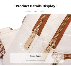 Detail of white textured leather bag with double zippers and golden metal pullers