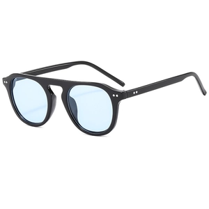 Modern vintage style sunglasses with blue tinted lenses and silver rivet accents