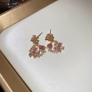 Macro shot of pink floral earrings with 18k gold plating and sparkling crystal details