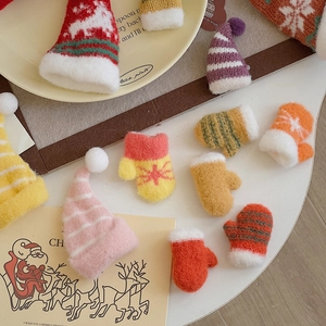 Close-up of mini knitted Christmas hats and gloves with festive snowflake and star patterns