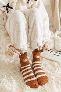 Detail of soft coral fleece socks with brown stripes and cute bear ear embroidery