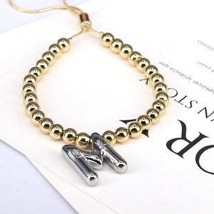 Adjustable beaded bracelet in gold with a silver 3D balloon initial M charm for women