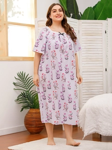 Close-up of floral nightdress featuring a square neckline with white lace and black bow
