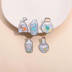 Set of 5 cartoon ocean creature enamel pins including clownfish and whale on white plates