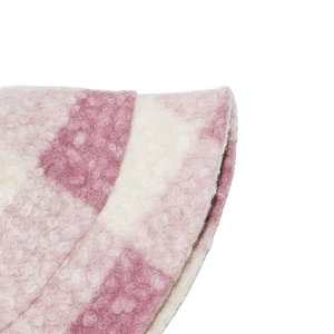 Macro detail of pink and cream checkerboard faux fur texture on a warm bucket hat