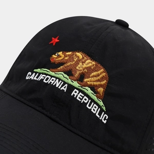 Close-up of California Republic bear embroidery on quick-dry black baseball cap