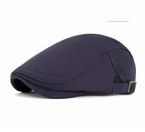 Detailed close-up of navy blue newsboy cap with textured metal adjustment buckle