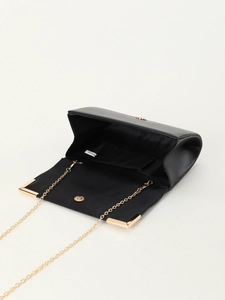 Detail view of the open black PU leather clutch bag with golden chain and magnetic clasp