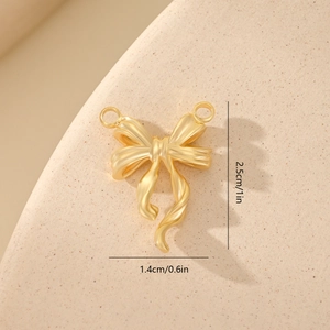 Macro shot showing dimensions of a golden zircon bow pendant for jewelry making