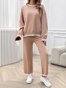 Close-up of khaki knitted two-piece set featuring elegant white stripe detail accents