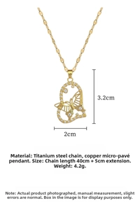 Detailed view of gold butterfly heart pendant necklace with white zircon inlays