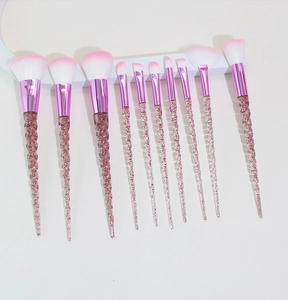 Detailed set of 10 unicorn makeup brushes with pink gradient bristles and glitter handles