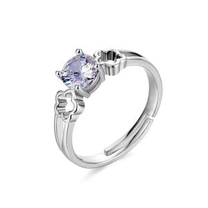 Macro detail of adjustable silver ring featuring purple zircon and clover hollow design