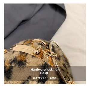 Close-up of golden hardware lock with rhinestones on a leopard faux fur handbag