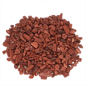 Polished red goldstone tumbled crystal chips for healing and decor on white background