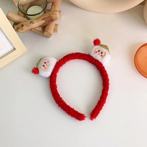 Close-up of red plush Christmas headband featuring cute Santa Claus plush doll ornaments